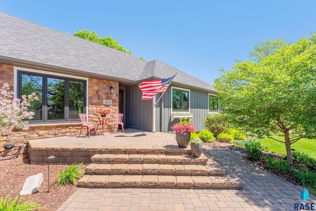 408 N Oak Ridge Rd, Brandon, SD 57005 - property entrance with roof with shingles and stone siding