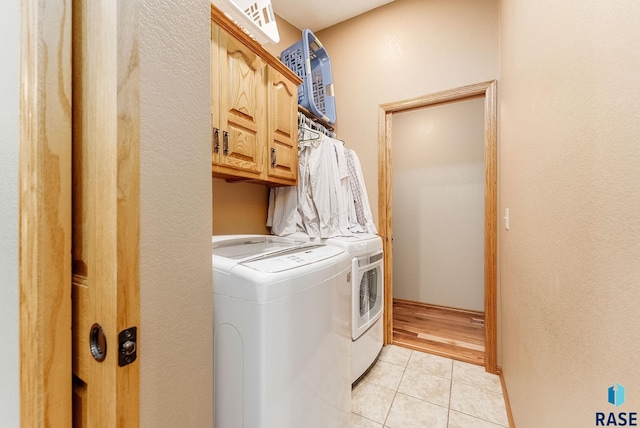 408 N Oak Ridge Rd, Brandon, SD 57005 - clothes washing area with separate washer and dryer, cabinet space, light tile patterned floors, and a textured wall