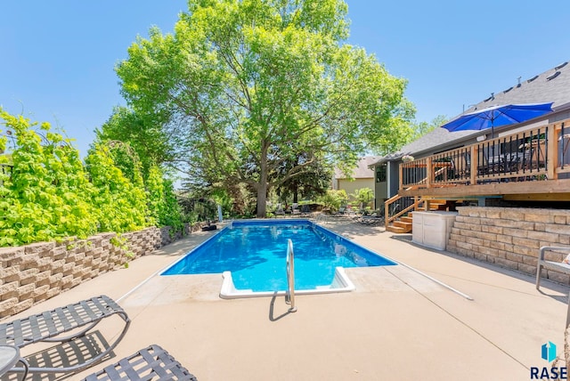 408 N Oak Ridge Rd, Brandon, SD 57005 - outdoor pool featuring a patio, a wooden deck, and stairway