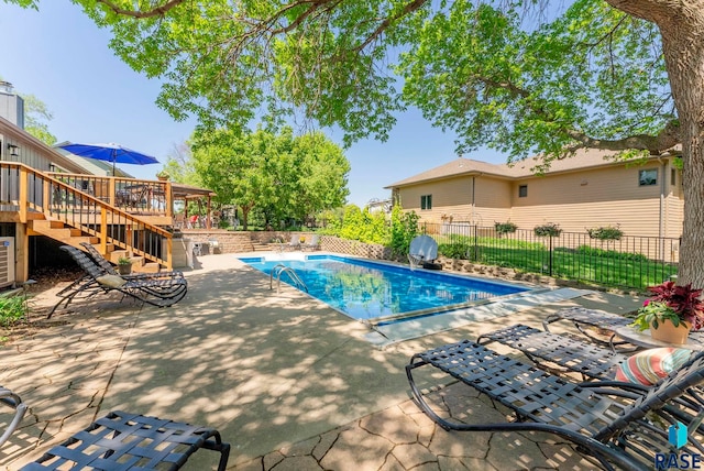 408 N Oak Ridge Rd, Brandon, SD 57005 - view of swimming pool with stairway, a wooden deck, a patio, and fence