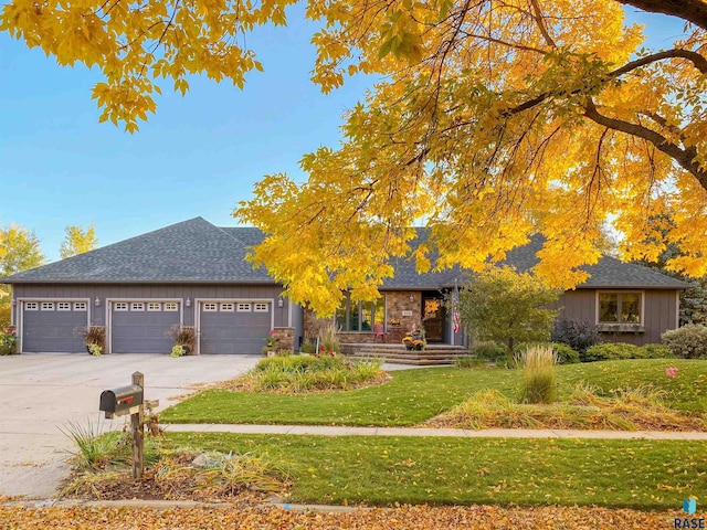408 N Oak Ridge Rd, Brandon, SD 57005 - obstructed view of property with a front lawn, an attached garage, concrete driveway, and roof with shingles