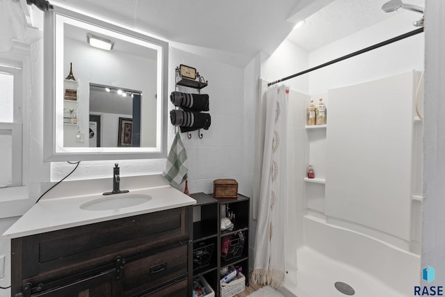 bathroom featuring a stall shower and vanity