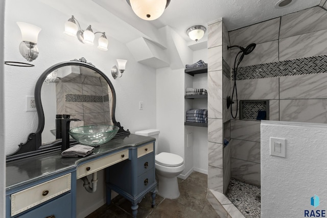 bathroom featuring a walk in shower, vanity, and toilet