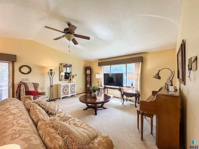 2204 S Melanie Ln, Sioux Falls, SD 57103 - living area featuring ceiling fan, vaulted ceiling, carpet floors, plenty of natural light, and a textured ceiling