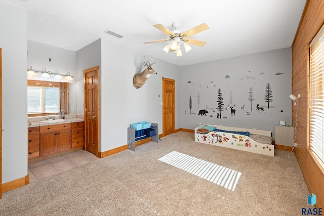 31780 476th Ave, Elk Point, SD 57025 - unfurnished bedroom featuring light colored carpet, multiple windows, baseboards, and ensuite bath
