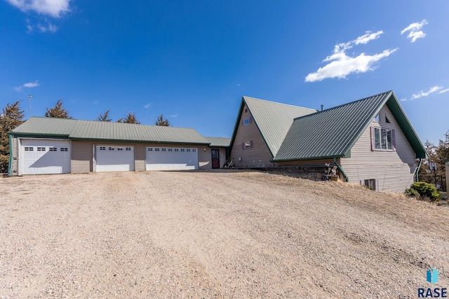 31780 476th Ave, Elk Point, SD 57025 - view of property exterior with a detached garage, metal roof, and cooling unit