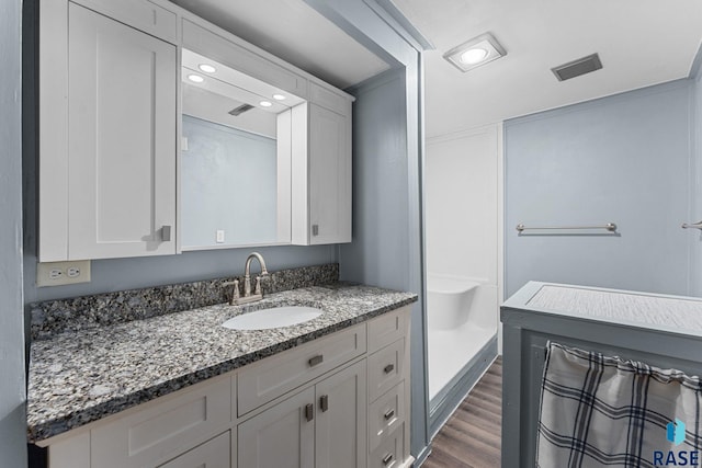 1712 S Bruce Rd, Sioux Falls, SD 57105 - bathroom with vanity, wood finished floors, recessed lighting, and a shower with curtain