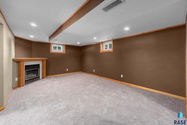 1712 S Bruce Rd, Sioux Falls, SD 57105 - below grade area featuring carpet flooring, recessed lighting, plenty of natural light, a glass covered fireplace, and baseboards