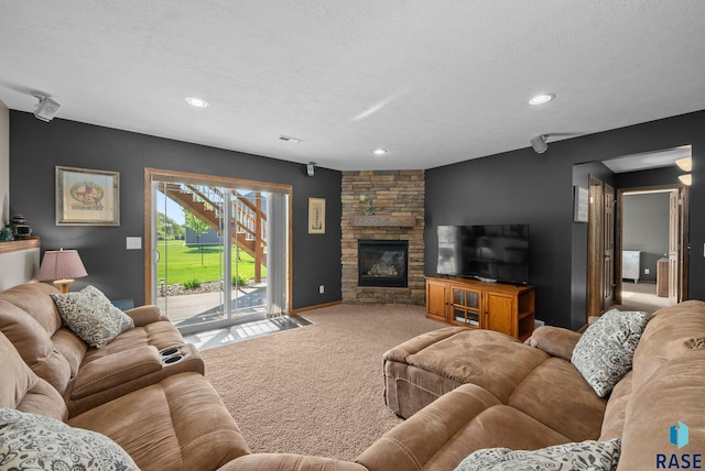 2320 N Ivy Rd, Tea, SD 57064 - carpeted living area with recessed lighting, a textured ceiling, and a stone fireplace