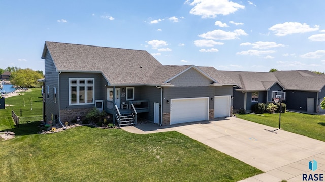 2320 N Ivy Rd, Tea, SD 57064 - view of front of property featuring a front lawn, a garage, driveway, and stone siding