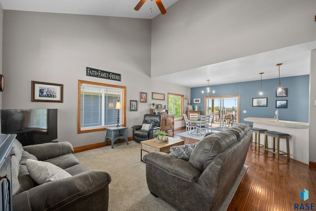 2320 N Ivy Rd, Tea, SD 57064 - living area featuring a ceiling fan, baseboards, a towering ceiling, wood finished floors, and a chandelier