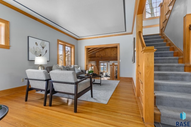 705 E 21st St, Sioux Falls, SD 57105 - living room featuring stairway, light wood finished floors, ornamental molding, and baseboards