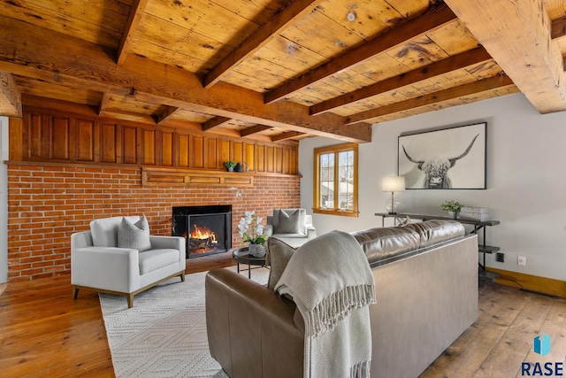 705 E 21st St, Sioux Falls, SD 57105 - living area with light wood-type flooring, a fireplace, wooden ceiling with exposed beams, and baseboards