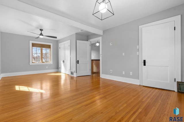 705 E 21st St, Sioux Falls, SD 57105 - unfurnished living room featuring light wood-type flooring, baseboards, and a ceiling fan