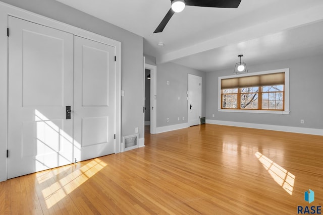 705 E 21st St, Sioux Falls, SD 57105 - unfurnished living room with a ceiling fan, light wood-style flooring, and baseboards