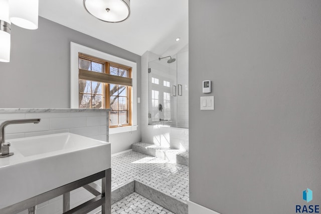 705 E 21st St, Sioux Falls, SD 57105 - bathroom with baseboards, a stall shower, a sink, lofted ceiling, and tile patterned flooring