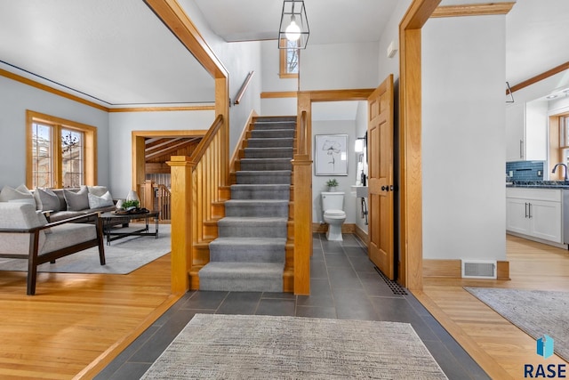 705 E 21st St, Sioux Falls, SD 57105 - stairway with crown molding and tile patterned floors