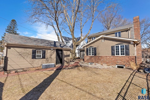 705 E 21st St, Sioux Falls, SD 57105 - rear view of property featuring a chimney and an outbuilding
