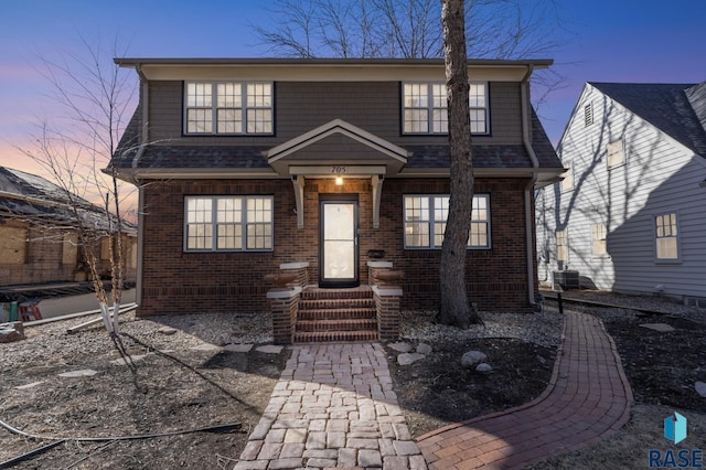 705 E 21st St, Sioux Falls, SD 57105 - view of front facade featuring cooling unit and brick siding