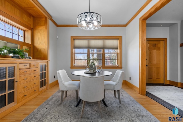 705 E 21st St, Sioux Falls, SD 57105 - dining room featuring light wood-style floors, a chandelier, crown molding, and baseboards