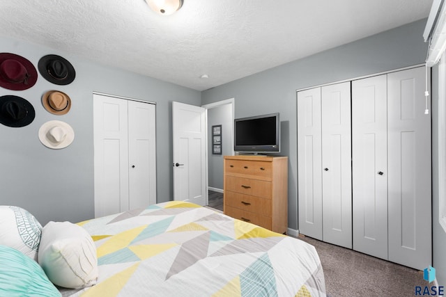 bedroom with carpet floors, baseboards, and a textured ceiling
