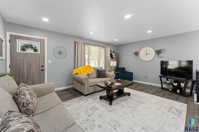 living room featuring dark wood-type flooring, recessed lighting, and baseboards