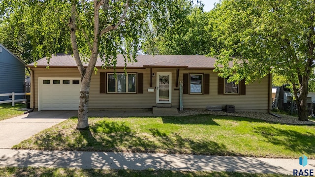 ranch-style house featuring an attached garage, concrete driveway, and entry steps