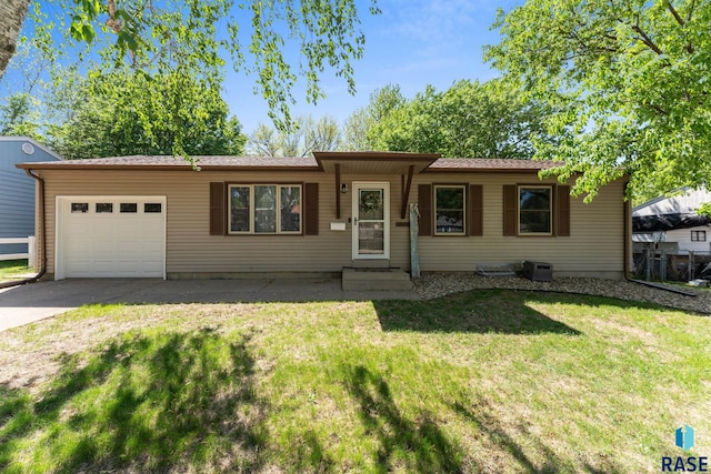 ranch-style house featuring a garage, driveway, and a front yard