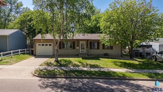 ranch-style home featuring an attached garage, driveway, and a shingled roof