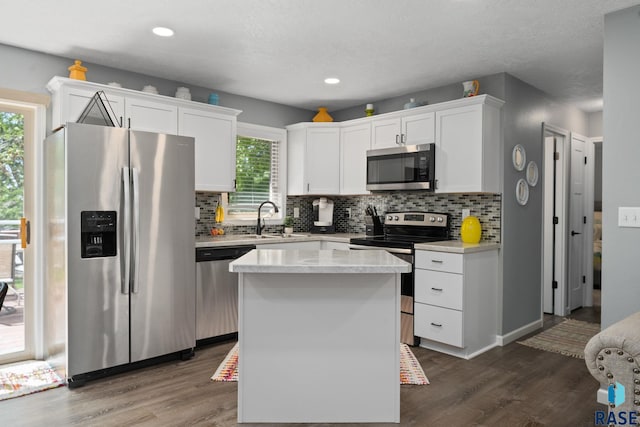 kitchen with appliances with stainless steel finishes, decorative backsplash, dark wood-type flooring, and recessed lighting