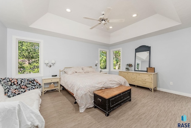 bedroom featuring multiple windows, recessed lighting, a raised ceiling, and ceiling fan