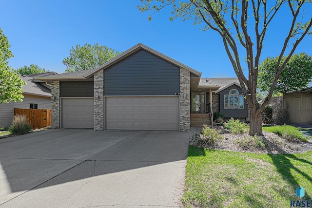 2608 S Rutgers Ave, Sioux Falls, SD 57106 - mid-century home featuring an attached garage, concrete driveway, and brick siding