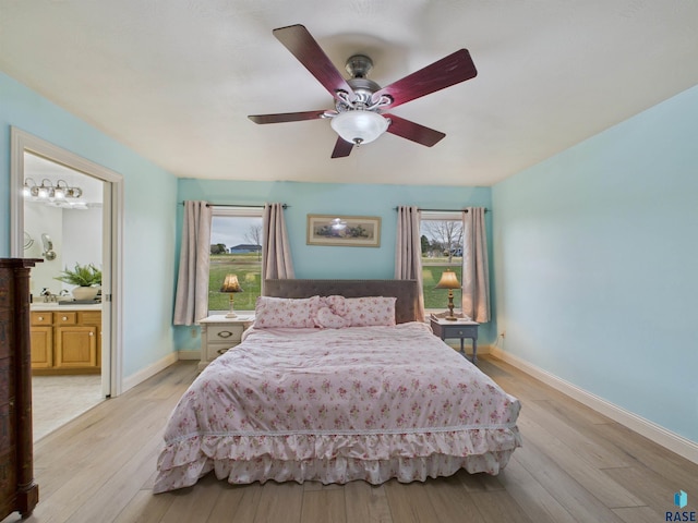 48288 Arrowhead Ct, Canton, SD 57013 - bedroom featuring light wood-type flooring, baseboards, ensuite bath, and ceiling fan