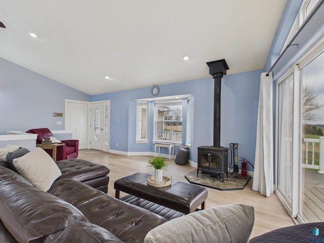 48288 Arrowhead Ct, Canton, SD 57013 - living area featuring a wood stove, lofted ceiling, light wood-style floors, baseboards, and recessed lighting