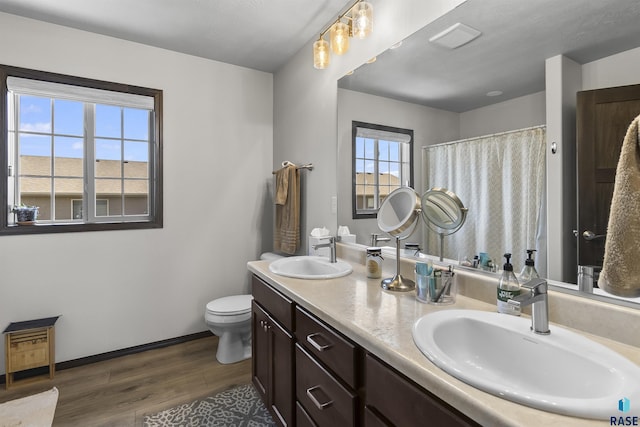 2541 E Meadowside Pl, Sioux Falls, SD 57108 - full bathroom featuring wood finished floors, toilet, baseboards, double vanity, and curtained shower