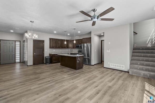 2541 E Meadowside Pl, Sioux Falls, SD 57108 - kitchen featuring appliances with stainless steel finishes, light countertops, a sink, dark brown cabinetry, and ceiling fan