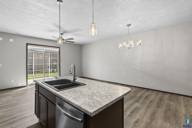 2541 E Meadowside Pl, Sioux Falls, SD 57108 - kitchen featuring a sink, dishwasher, wood finished floors, light countertops, and a textured ceiling