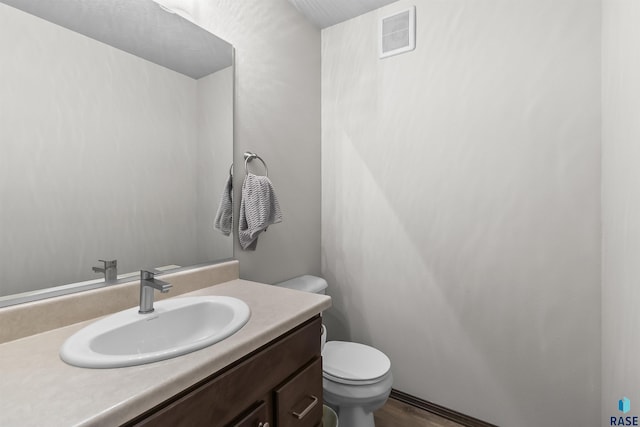 2541 E Meadowside Pl, Sioux Falls, SD 57108 - bathroom featuring toilet, vanity, and wood finished floors