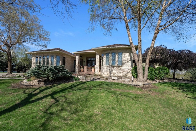 back of house with a lawn and covered porch