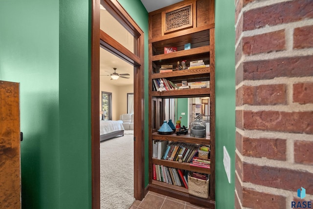 corridor featuring carpet flooring and tile patterned flooring