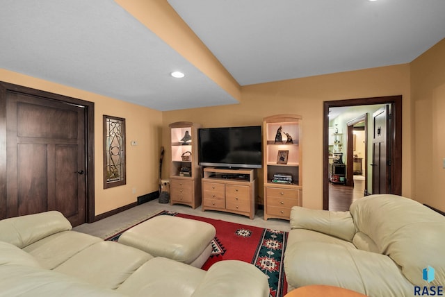 living room with recessed lighting, light colored carpet, and baseboards