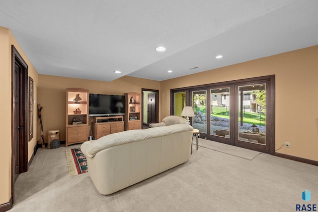 living area featuring light colored carpet, baseboards, and recessed lighting