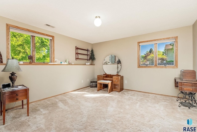 living area with baseboards and carpet flooring