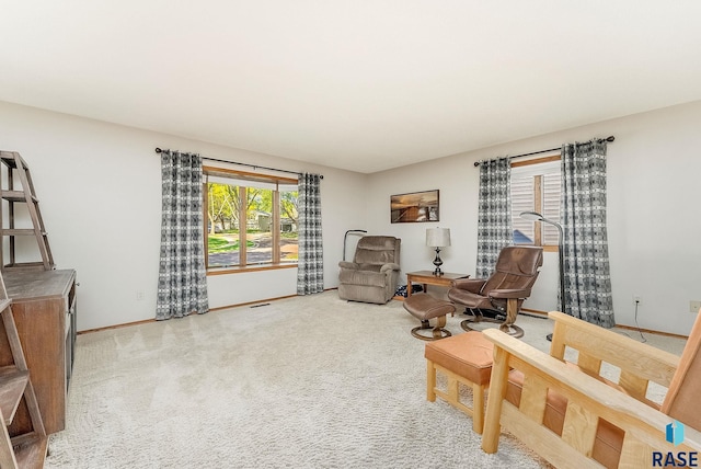 sitting room featuring baseboards and carpet