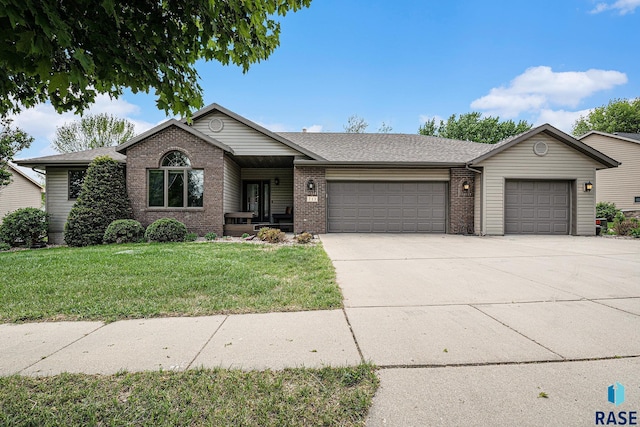 711 Britz Dr, Luverne, MN 56156 - single story home with a garage, concrete driveway, brick siding, a front lawn, and roof with shingles