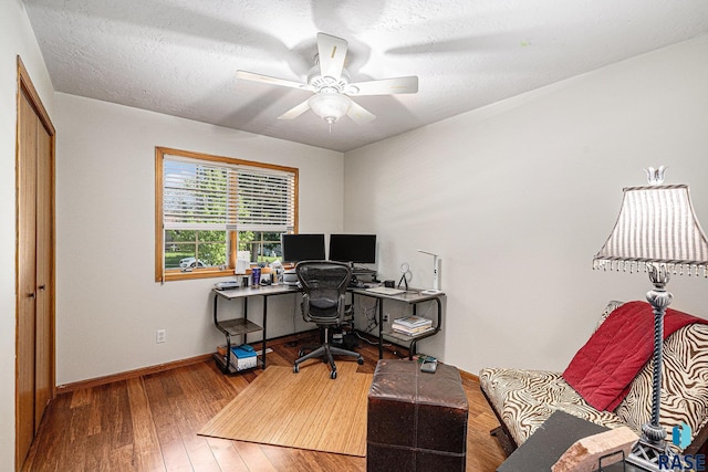 711 Britz Dr, Luverne, MN 56156 - home office featuring wood finished floors, ceiling fan, baseboards, and a textured ceiling