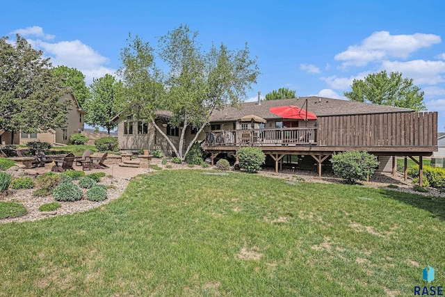 711 Britz Dr, Luverne, MN 56156 - back of property featuring an outdoor fire pit, a wooden deck, a patio, and a lawn