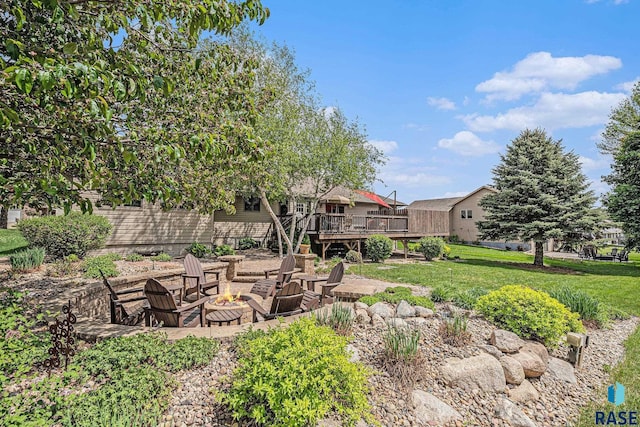 711 Britz Dr, Luverne, MN 56156 - view of green lawn featuring a deck and a fire pit