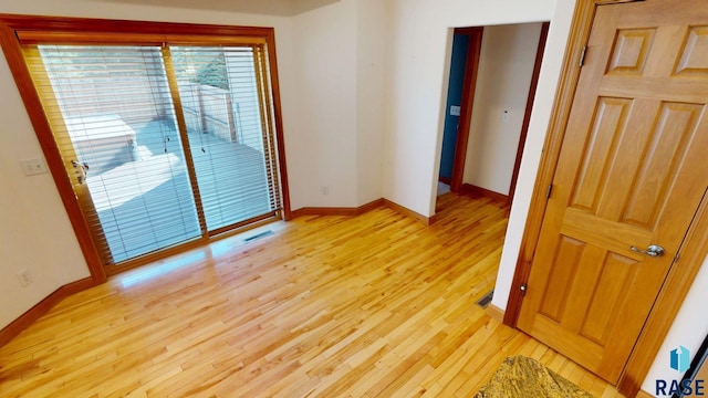 851 Regency Ct, Brookings, SD 57006 - unfurnished room with light wood finished floors and baseboards