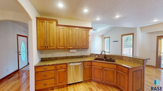 851 Regency Ct, Brookings, SD 57006 - kitchen featuring a sink, dishwasher, a peninsula, light wood-type flooring, and brown cabinets